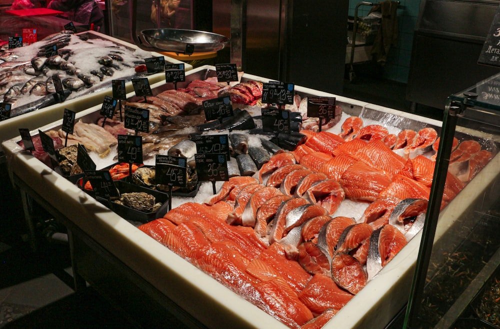 Fresh seafood market display with salmon cuts on ice